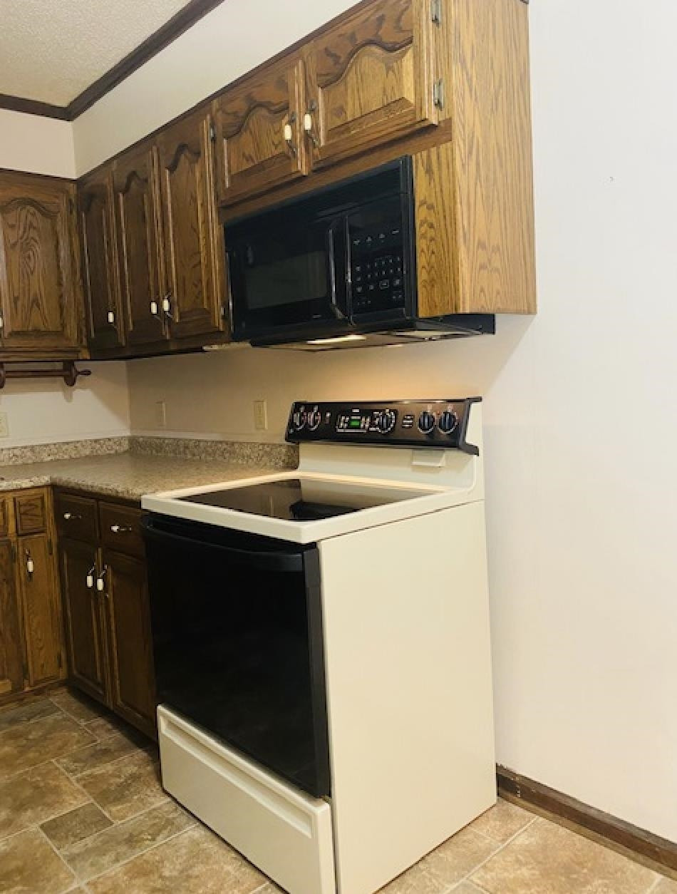 109 Morris Drive Rutherford, TN 38369 - Photo 11 of 18 a kitchen with stainless steel appliances wooden cabinets and a stove top oven