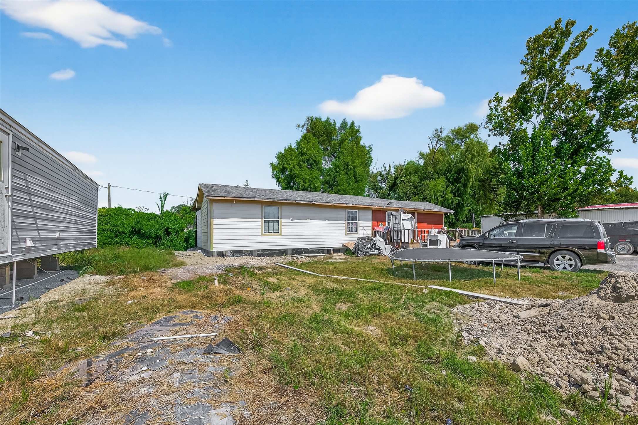 14215 Sweeney Road Houston, TX 77060 - Photo 2 of 5 a house view with swimming pool and trees in the background