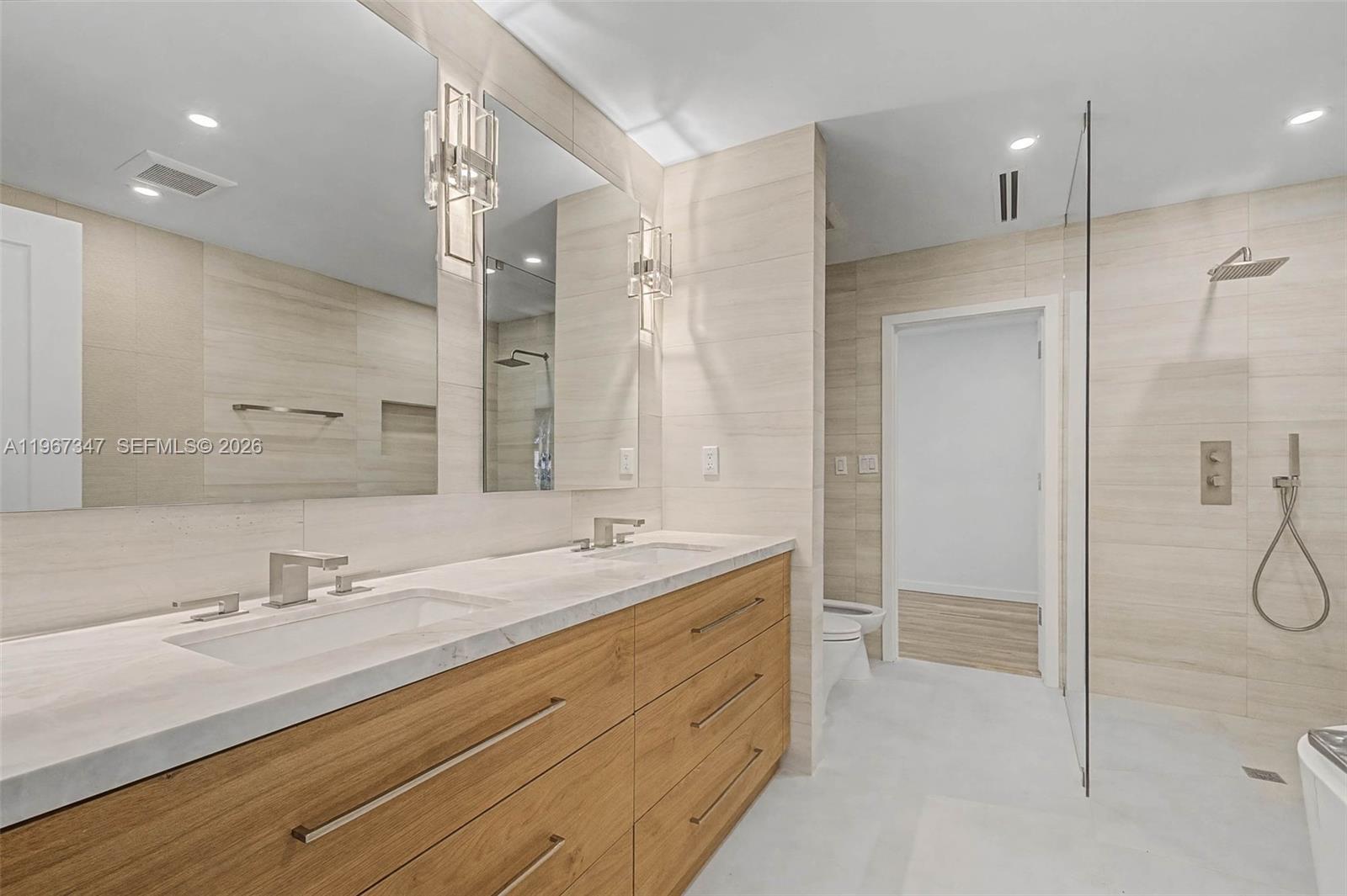 12940 Southwest 73rd Avenue Pinecrest, FL 33156 - Photo 13 of 38 a bathroom with a double vanity sink mirror and double