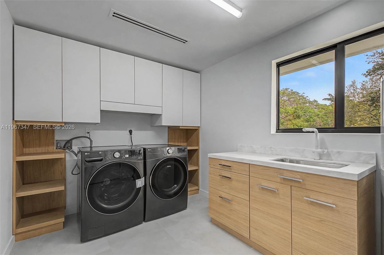 12940 Southwest 73rd Avenue Pinecrest, FL 33156 - Photo 16 of 38 a utility room with sink dryer and washer