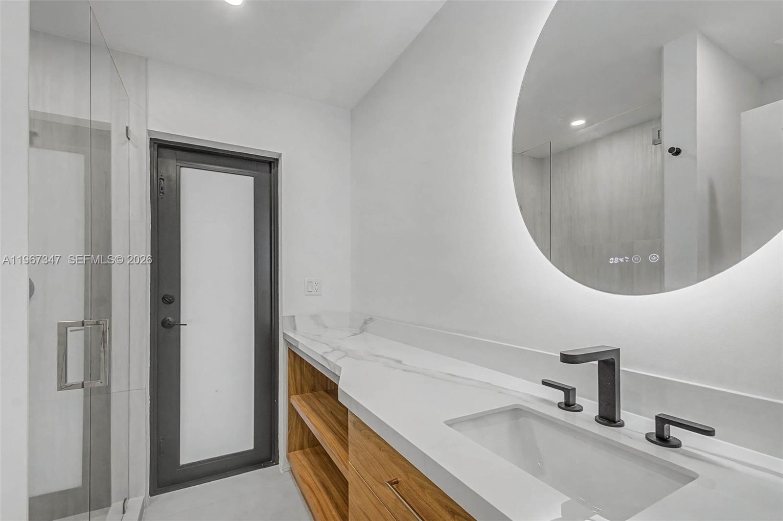 12940 Southwest 73rd Avenue Pinecrest, FL 33156 - Photo 20 of 38 a bathroom with a sink and a mirror