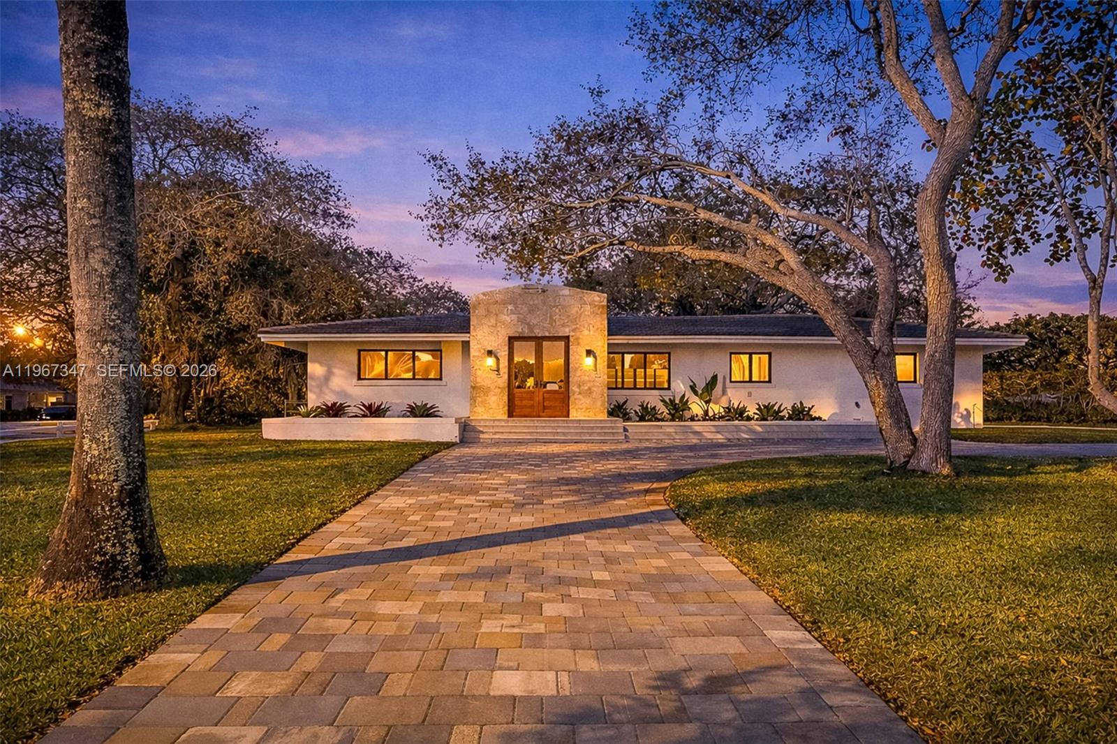 12940 Southwest 73rd Avenue Pinecrest, FL 33156 - Photo 2 of 38 a view of swimming pool with a garden and trees
