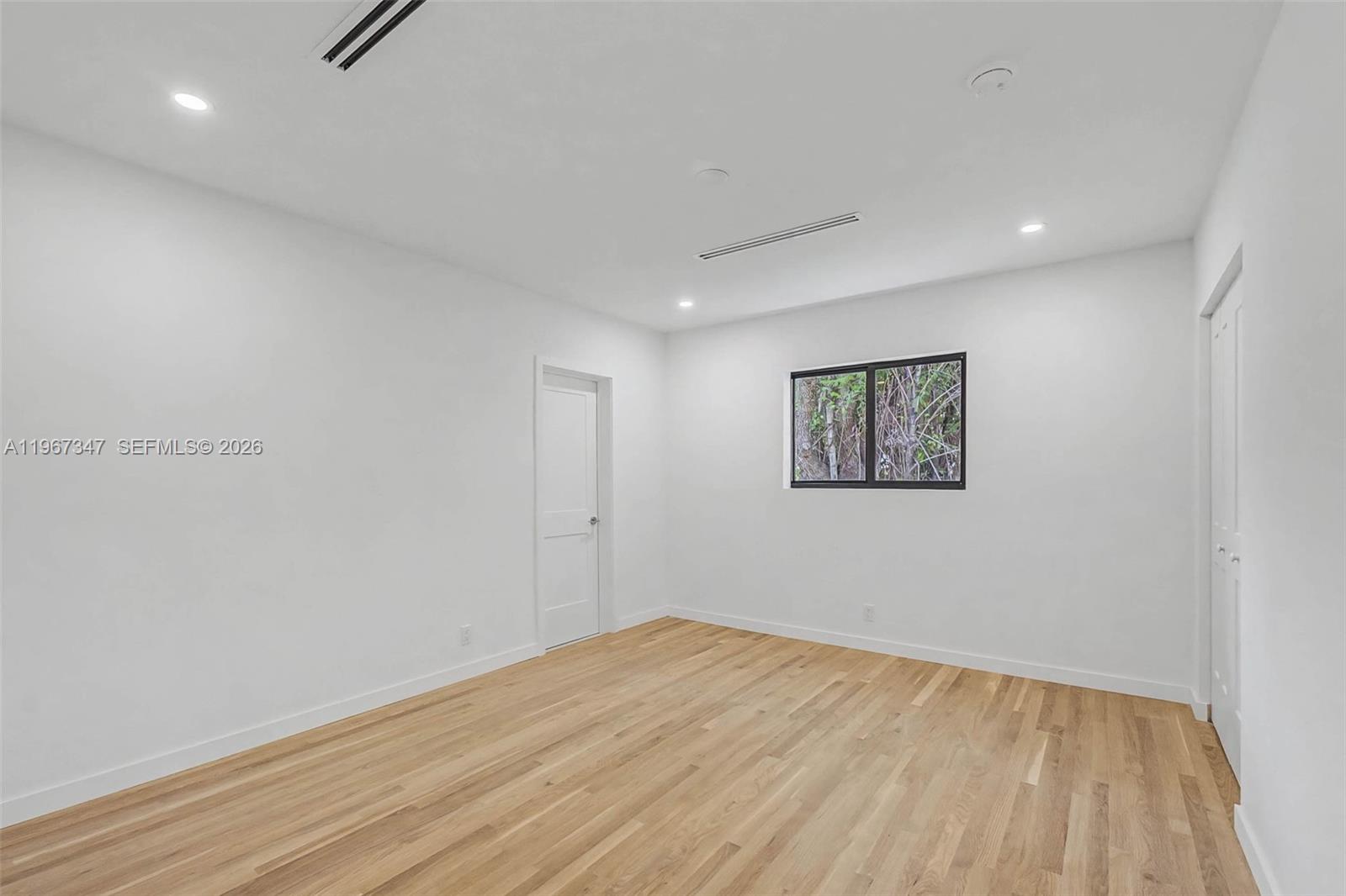 12940 Southwest 73rd Avenue Pinecrest, FL 33156 - Photo 24 of 38 a view of empty room with wooden floor and fan