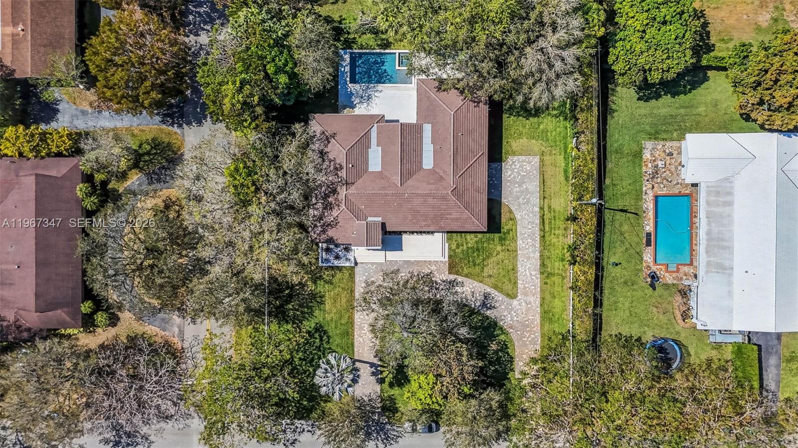 12940 Southwest 73rd Avenue Pinecrest, FL 33156 - Photo 37 of 38 an aerial view of a house with a yard and large trees
