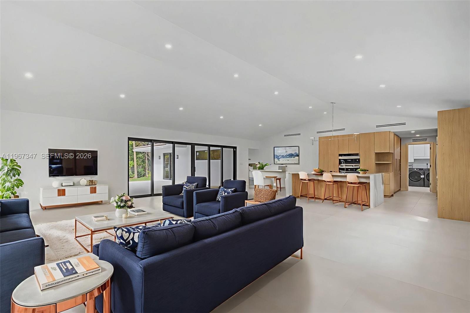 12940 Southwest 73rd Avenue Pinecrest, FL 33156 - Photo 5 of 38 a living room with furniture and a flat screen tv