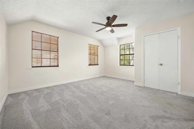 a bathroom with a granite countertop sink a mirror a vanity and a bathtub