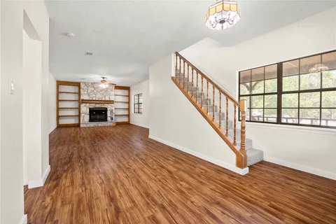 a kitchen with granite countertop a sink stove and refrigerator