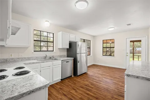 a kitchen with a stove top oven and cabinets