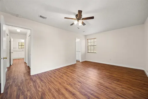 a bathroom with a granite countertop sink two mirror and shower