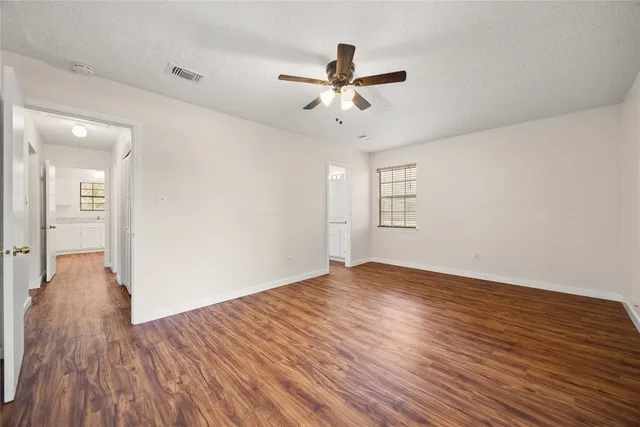 a bathroom with a granite countertop sink two mirror and shower