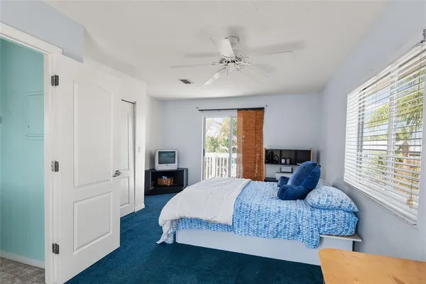 a bedroom with a bed and a flat tv screen