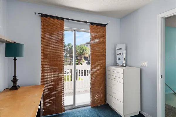 a bedroom with a large bed and a large window