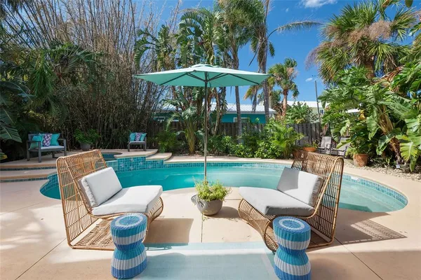 a view of a patio with couches chairs and a yard
