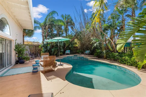 a view of a chairs and table in the backyard
