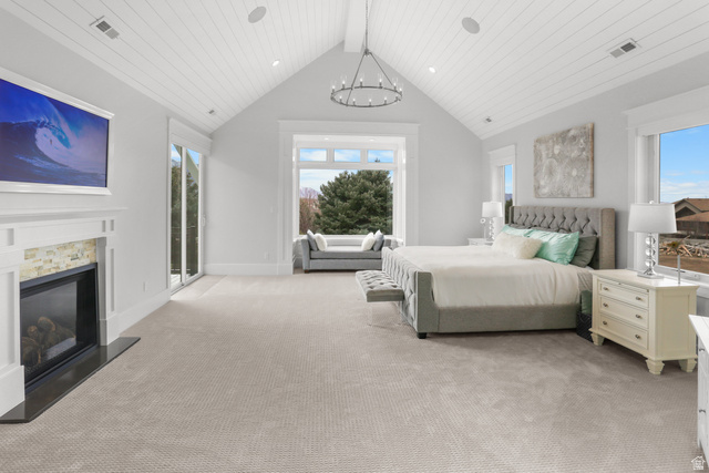 1354 South 800 East Mapleton, UT 84664 - Photo 7 of 129 Bedroom featuring light carpet, a glass covered fireplace, a high wooden ceiling, and hanging lights