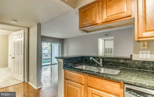 a kitchen with granite countertop a sink and a cabinets
