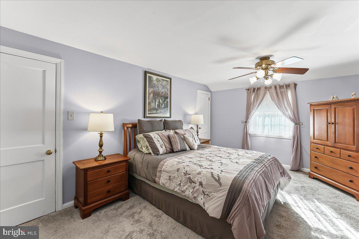 243 Rambling Way Springfield, PA 19064 - Photo 20 of 42 a bedroom with a bed and a chandelier