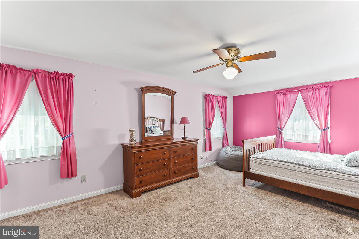 243 Rambling Way Springfield, PA 19064 - Photo 22 of 42 a bedroom with a bed and a chandelier