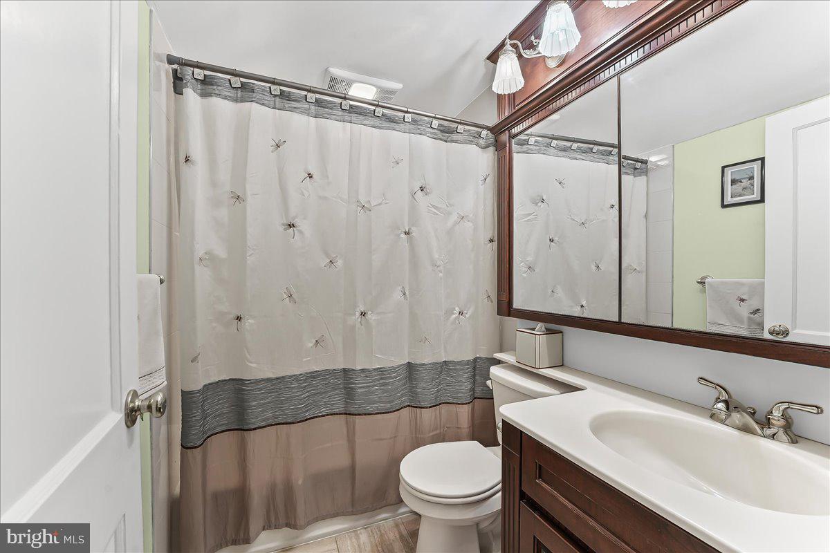 243 Rambling Way Springfield, PA 19064 - Photo 24 of 42 a bathroom with a sink a toilet a mirror and shower