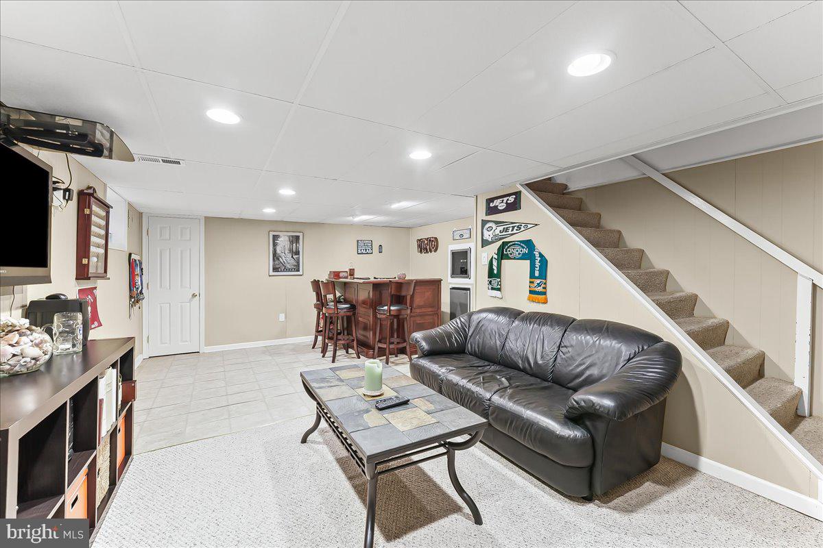 243 Rambling Way Springfield, PA 19064 - Photo 28 of 42 a living room with furniture and a flat screen tv