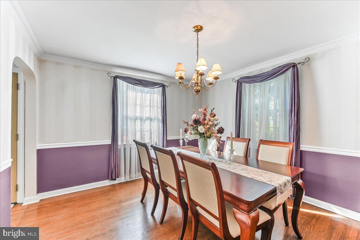 243 Rambling Way Springfield, PA 19064 - Photo 7 of 42 a dining room with furniture a chandelier and wooden floor