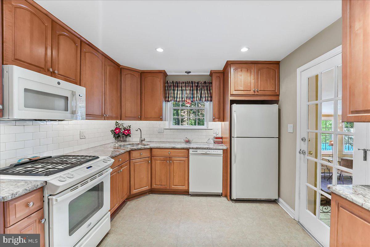243 Rambling Way Springfield, PA 19064 - Photo 10 of 42 a kitchen with stainless steel appliances granite countertop a refrigerator stove and sink