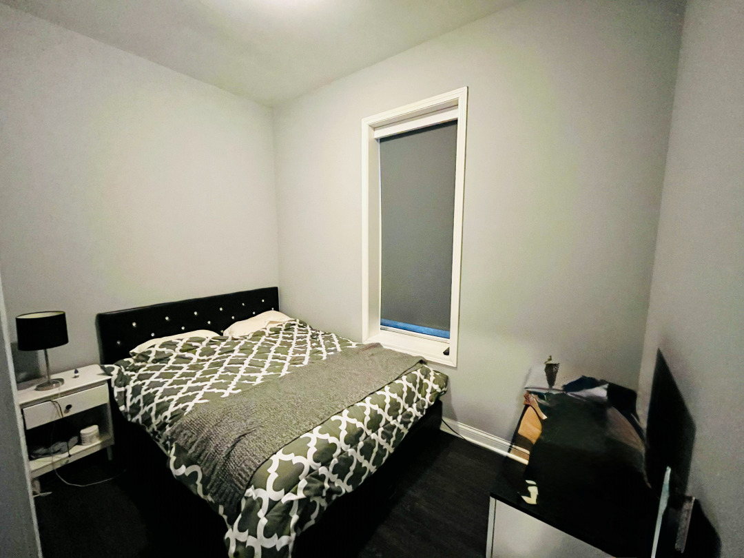 1300 North Greenview Avenue, Unit 2F Chicago, IL 60642 - Photo 8 of 11 a bedroom with a bed and a window