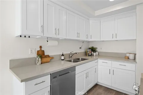 a kitchen with white cabinets and white appliances
