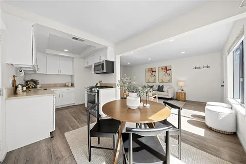 a kitchen with a dining table and chairs