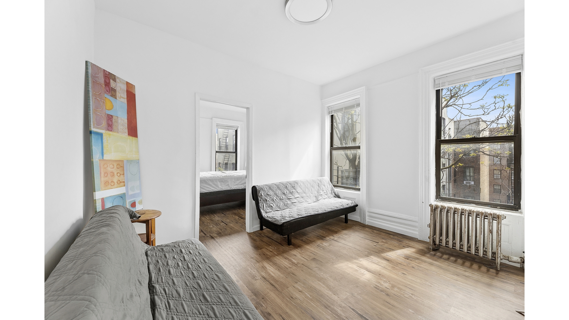30 Macombs Place, Unit 54 Manhattan, NY 10039 - Photo 1 of 6 a bedroom with a bed and wooden floor