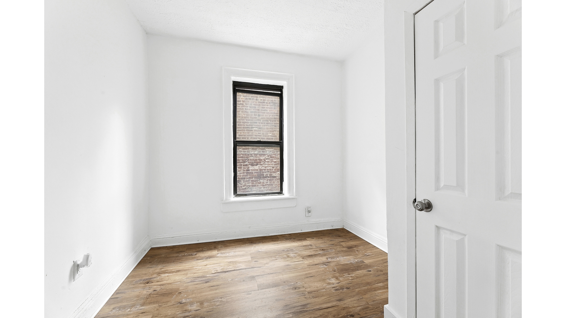 30 Macombs Place, Unit 54 Manhattan, NY 10039 - Photo 2 of 6 a view of an empty room with closet and a window