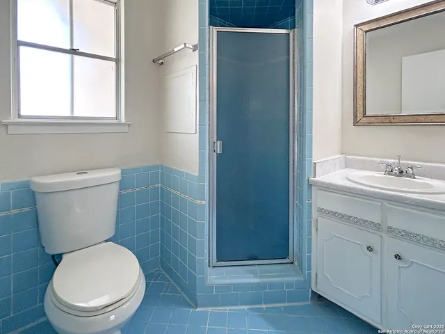 a white toilet sitting next to a bathroom sink
