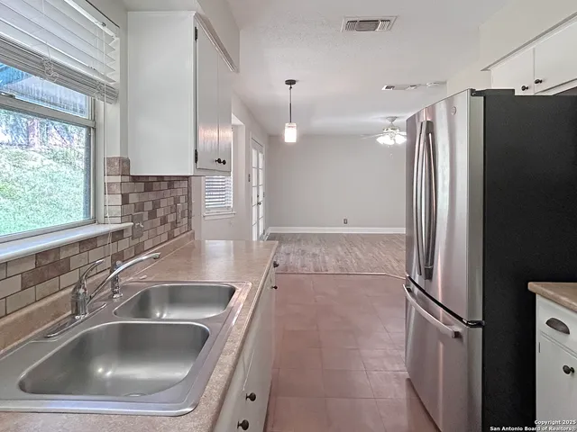 a kitchen with a sink and a refrigerator