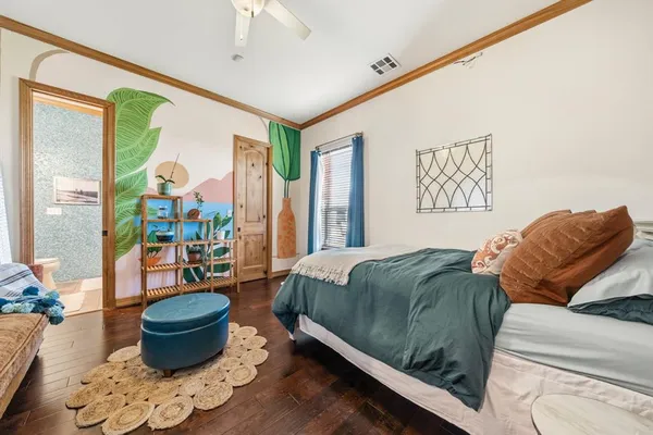 a bedroom with a bed and a large window