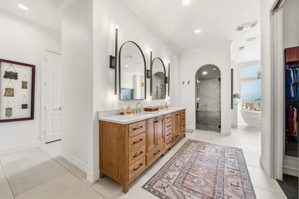 a spacious bathroom with a double vanity sink and a mirror