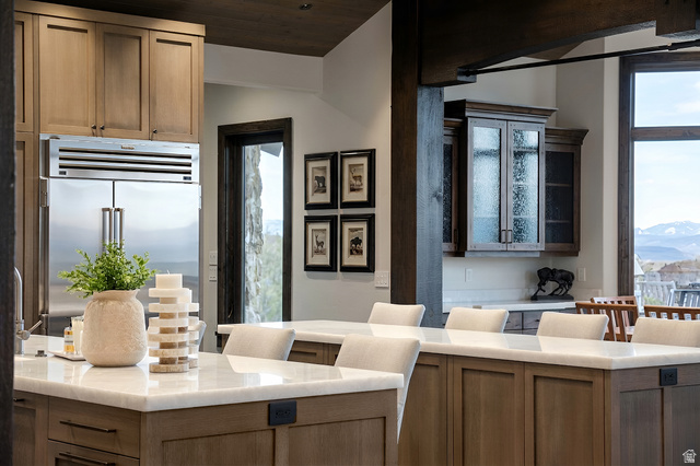 9156 Forest Road, Unit 24 Heber City, UT 84036 - Photo 11 of 42 Kitchen island with light-toned wood cabinetry and white countertops