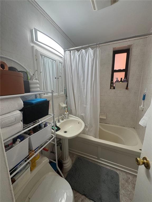 2400 East 3rd Street, Unit 317 Brooklyn, NY 11223 - Photo 6 of 8 a bathroom with a sink toilet and shower