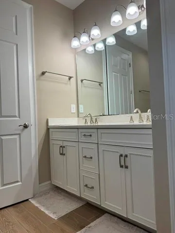 a bathroom with a sink double vanity and a mirror