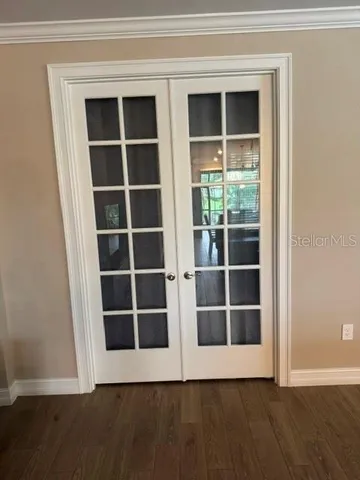 a view of wooden floor and windows in a room