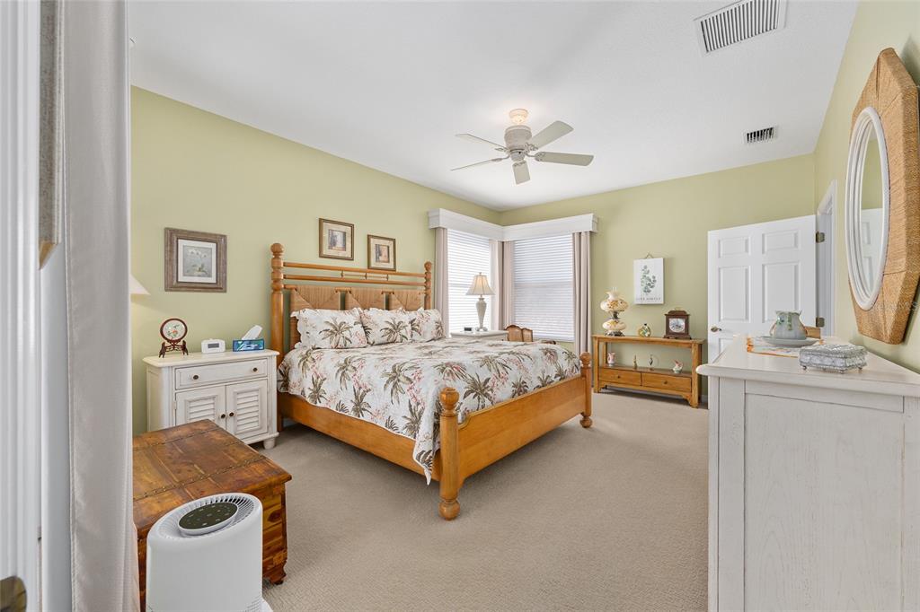 16339 Southwest 14th Avenue Road Ocala, FL 34473 - Photo 11 of 22 a bedroom with a bed and a chandelier