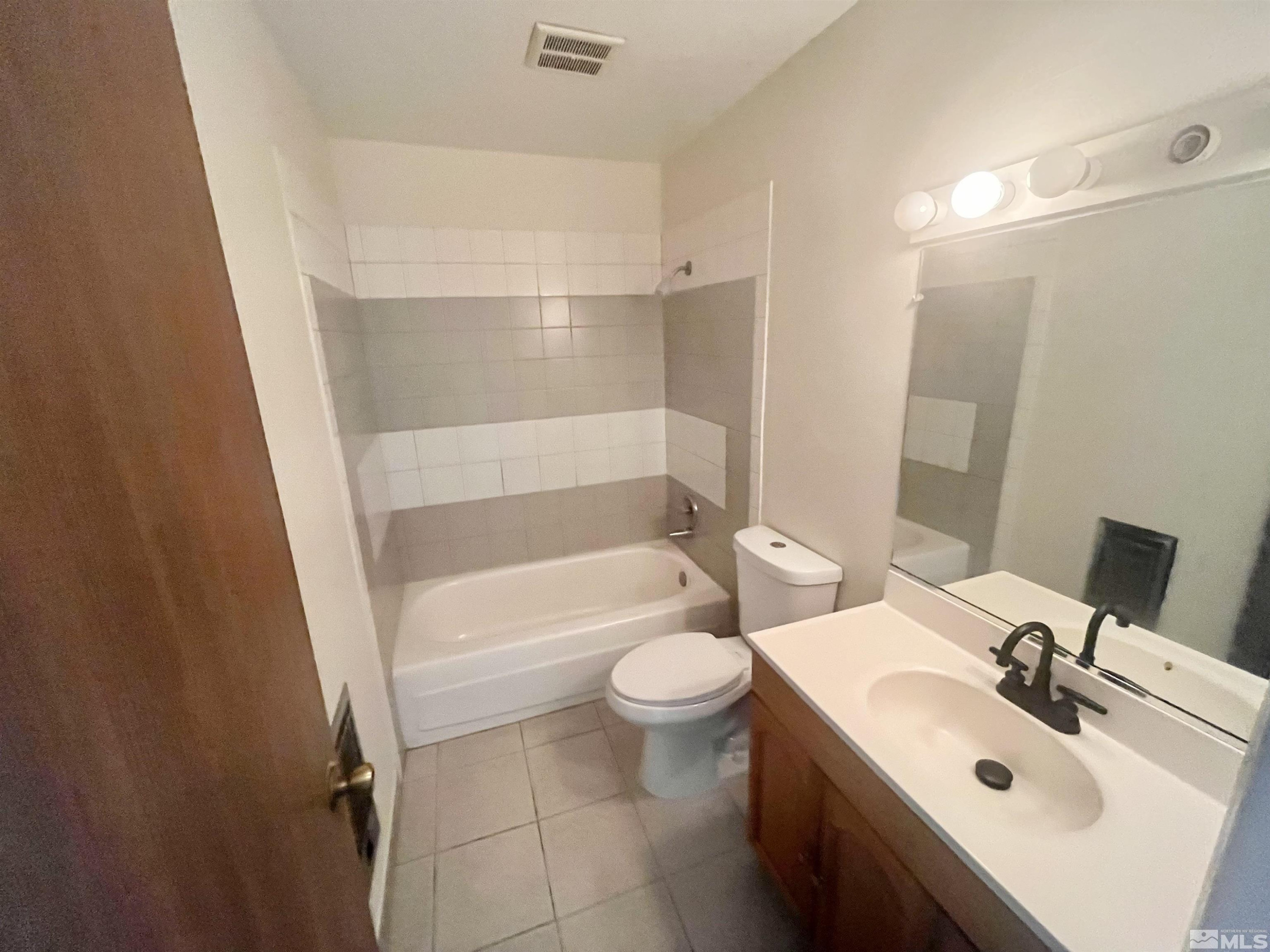 445 Pine Meadows Drive, Unit 29 Sparks, NV 89431 - Photo 8 of 13 a bathroom with a sink a toilet and shower