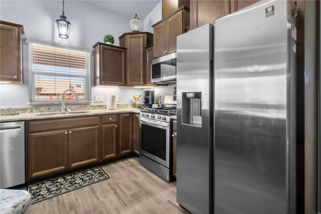 3897 Easy Street Kingman, AZ 86409 - Photo 12 of 53 a kitchen with stainless steel appliances granite countertop a refrigerator a sink a stove and island