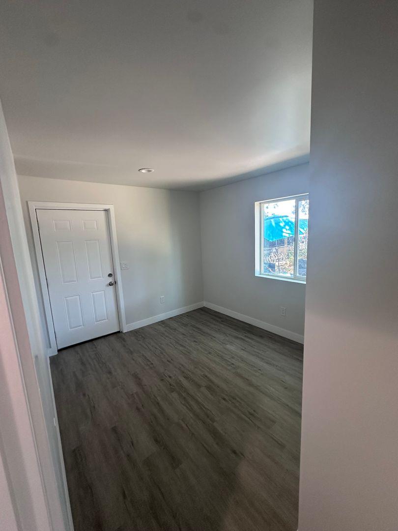 454 Colin Kelly Drive Roseville, CA 95747 - Photo 11 of 13 an empty room with wooden floor cabinet and windows