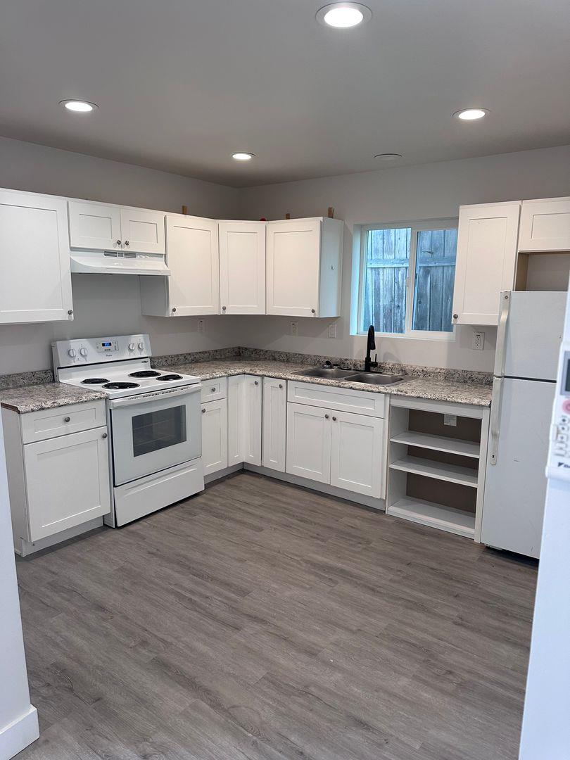454 Colin Kelly Drive Roseville, CA 95747 - Photo 2 of 13 a kitchen with a white cabinets and white appliances