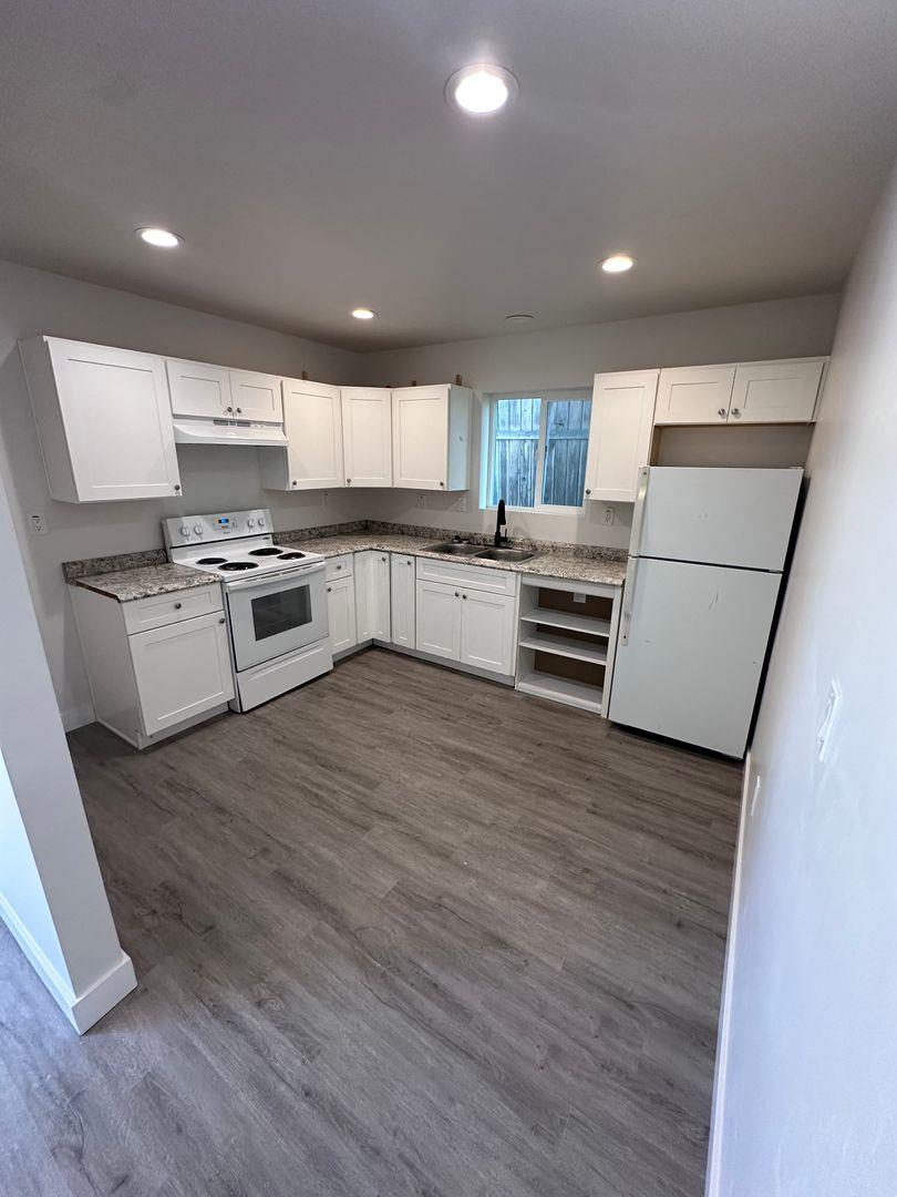 454 Colin Kelly Drive Roseville, CA 95747 - Photo 3 of 13 a kitchen with stainless steel appliances wooden floors and wooden cabinets