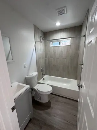 a bathroom with a double vanity sink toilet and shower