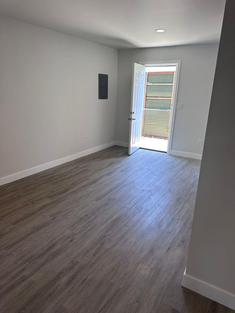 454 Colin Kelly Drive Roseville, CA 95747 - Photo 7 of 13 a view of an empty room with wooden floor and a window
