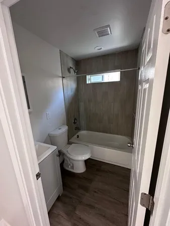 a bathroom with a toilet a sink and bathtub