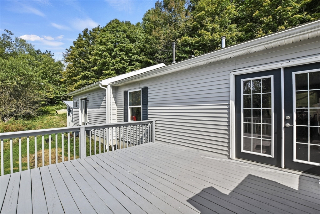 2792 Hancock Road Hancock, MA 01237 - Photo 14 of 38 a balcony with wooden floor and fence next to a yard