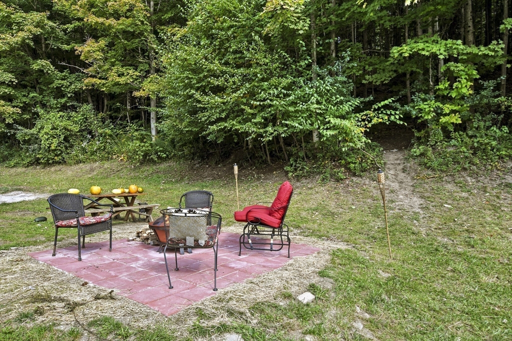 2792 Hancock Road Hancock, MA 01237 - Photo 24 of 38 a backyard with table and chairs and potted plants